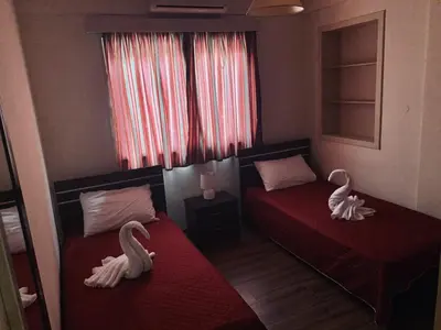 two beds in a room with swans on them at Kika Court 2 in Paralimni