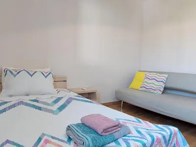 a bedroom with a bed and a couch at Amathousa Coastal Heights D202 in Limassol