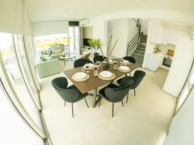 a dining room with a table and chairs at Imperial Jade Villas Gold Emerging Villas 2 in Protaras