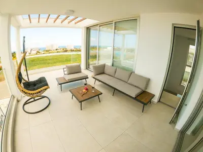 a living room with a couch and a table at Imperial Jade Villas Gold Emerging Villas 2 in Protaras