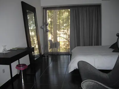 a bedroom with a bed and a desk and a window at Crystal Hotel in Kakopetria
