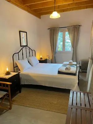 a bedroom with a large bed and a window at The Old Coffeehouse in Kalopanayiotis