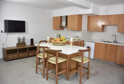 a kitchen with a table with a bowl of fruit on it at The Old Coffeehouse in Kalopanayiotis