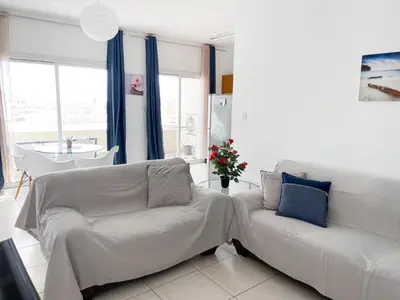 a living room with two white couches and a table at Apartment Capella, Larnaca in Larnaka