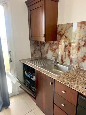 a kitchen with a sink and a counter top at Apartment Capella, Larnaca in Larnaka