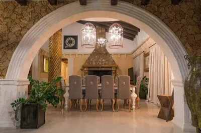 a dining room with a table and chairs and a fireplace at Grand Mansion Countryhouse & Spa in Phrenaros