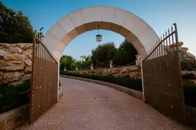 an archway over a brick path in a park at Grand Mansion Countryhouse & Spa in Phrenaros