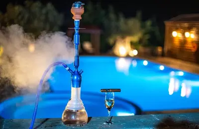 a drinking fountain with a glass of wine next to a pool at Grand Mansion Countryhouse & Spa in Phrenaros