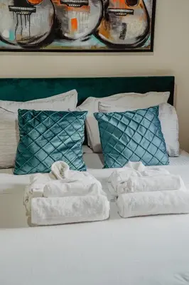 a bed with two towels sitting on top of it at The Stonehouse Suites with Private Bath Spas in Limassol