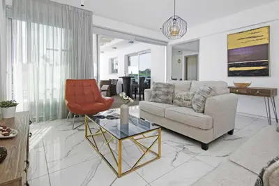 a living room with a couch and a table at Villa Napa View in Ayia Napa