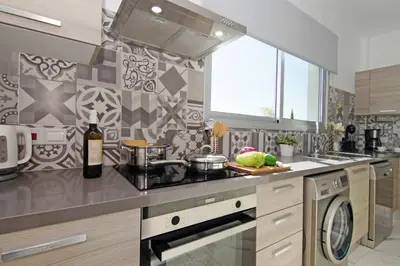 a kitchen with a sink and a stove top oven at Villa Napa View in Ayia Napa