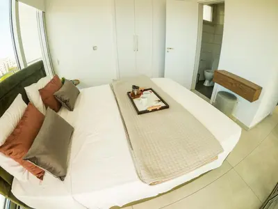 a white bed with a tray on top of it at Imperial Jade Villas Gold Emerging Villas 1 in Protaras