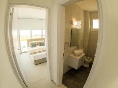 a bathroom with a sink and a toilet and a mirror at Imperial Jade Villas Gold Emerging Villas 1 in Protaras