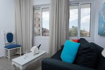 a living room with a couch and a table at Hotel Opera in Larnaka