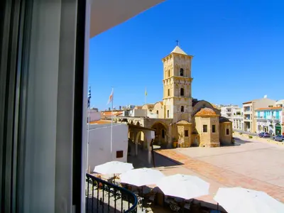 a view of a building with a clock tower at Hotel Opera in Larnaka