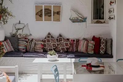 a living room with a couch with pillows on it at Hotel Opera in Larnaka