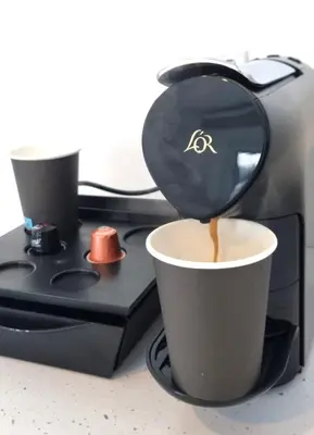 a coffee maker with a cup of coffee at TSANotel in Limassol