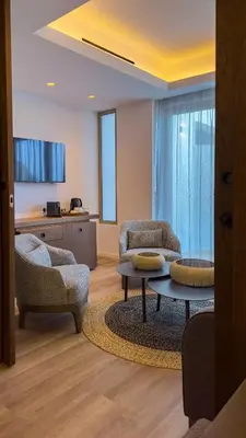 a living room with two chairs and a table at Tasia Maris Beach Hotel - Adults Only in Ayia Napa
