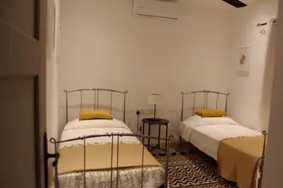 a bedroom with two beds and a table at skeleas 10 in Pissouri