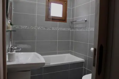 a bathroom with a sink and a bath tub at skeleas 10 in Pissouri