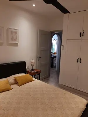 a bedroom with a large bed and an open door at skeleas 10 in Pissouri