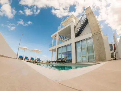 a house with a swimming pool in front of it at Imperial Jade Villas Gold Emerging Villas 3 in Protaras