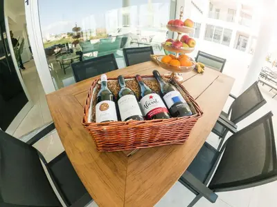 a basket of wine bottles sitting on a table at Imperial Jade Villas Gold Emerging Villas 3 in Protaras