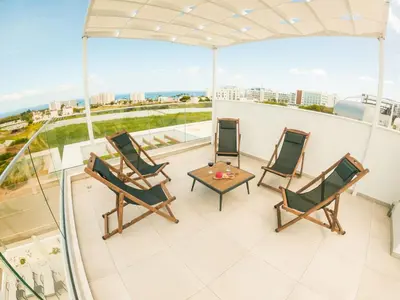 a balcony with chairs and a table on a building at Imperial Jade Villas Gold Emerging Villas 3 in Protaras