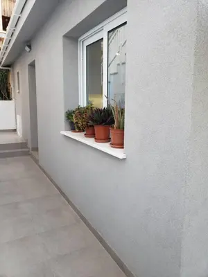 a window sill with potted plants on a building at Modern & Cozy Studio w/ Backyard Near City Center in Limassol