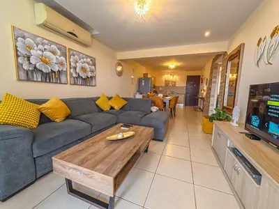 a living room with a couch and a coffee table at NISSI BEACH POOL VIEW APARTMENT FREE WIFI in Ayia Napa