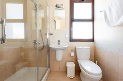 a bathroom with a toilet and a sink and a shower at Villa Alexandra by Ezoria Villas in Ayia Napa