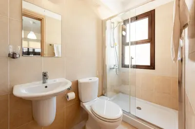 a bathroom with a toilet and a sink and a shower at Villa Alexandra by Ezoria Villas in Ayia Napa