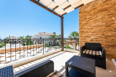 a balcony with two chairs and a table at Villa Alexandra by Ezoria Villas in Ayia Napa