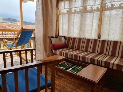 a living room with a couch and a table at Kassandras place in Omodos village in Omodos