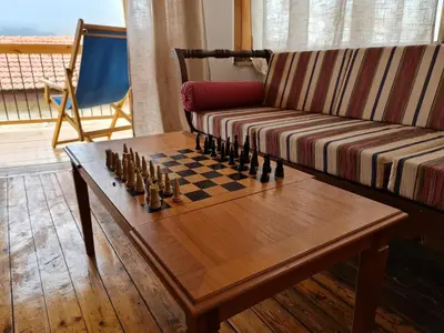 a living room with a chessboard on a coffee table at Kassandras place in Omodos village in Omodos