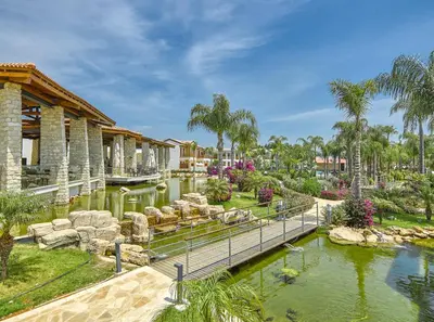 a resort with a pond and a water park at Olympic Lagoon Resort Ayia Napa in Ayia Napa