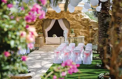 a row of chairs in front of a room with flowers at Olympic Lagoon Resort Ayia Napa in Ayia Napa