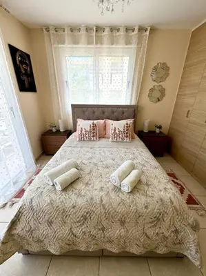 a bedroom with a large bed with two pillows at NISSI BEACH Apt 7 BIG VERANDA AND FREE WIFI in Ayia Napa