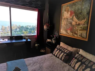 a bedroom with a painting on the wall and a bed at Artemis Boutique Apartment 2 in Limassol