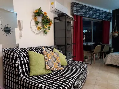 a living room with a black and white couch at Artemis Boutique Apartment 2 in Limassol