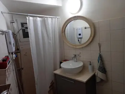 a bathroom with a sink and a mirror at Artemis Boutique Apartment 2 in Limassol