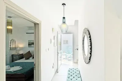 a living room with a bed and a mirror at Nissini Shell, 3 bedroom villa with private pool at Nissi Beach in Ayia Napa