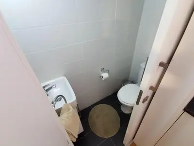 a small bathroom with a toilet and a sink at Daze Off Central Apartment, 300m to the Finikoudes Beach in Larnaka