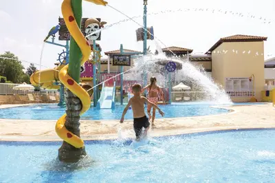 a young boy playing in a water park at Atlantica Aeneas Resort in Ayia Napa
