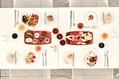 a white table with plates of food on it at Atlantica Aeneas Resort in Ayia Napa