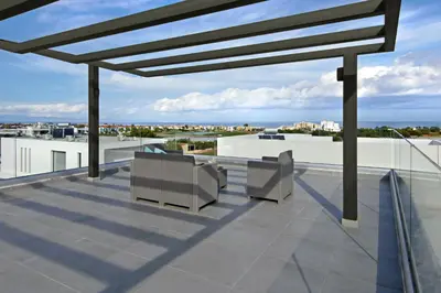 a roof deck with two chairs and a view at Villa Harmonia in Protaras