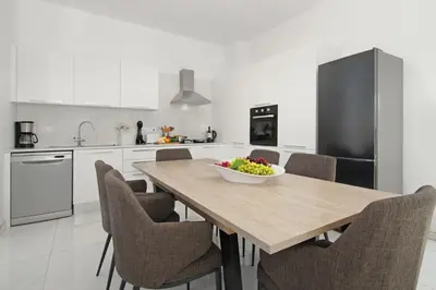 a kitchen with a wooden table with a bowl of fruit on it at Villa Harmonia in Protaras