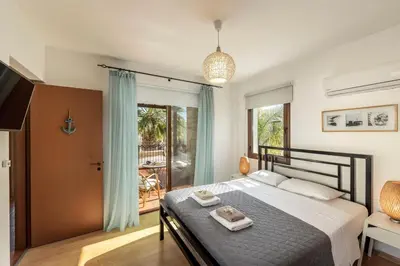 a bedroom with a large bed and a balcony at Villa Ionion 27 in Ayia Napa