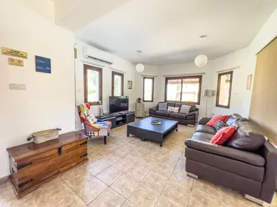 a living room with two couches and a tv at Leo's Paradise in Protaras