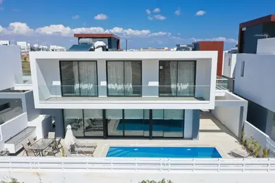 a house with a swimming pool on top of a building at Diamond villas in Protaras
